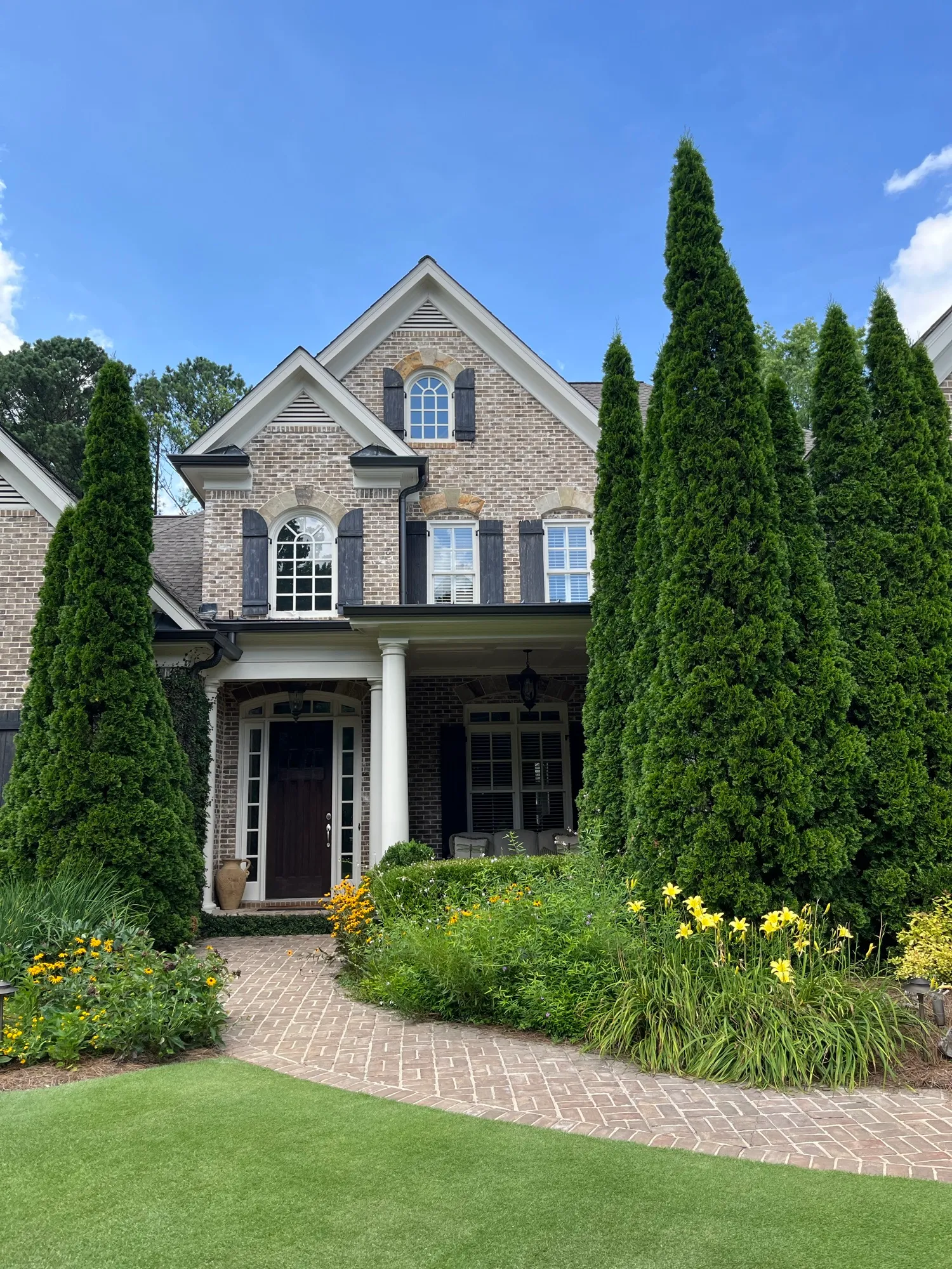 Clean windows on a brick traditional home with arched upper windows