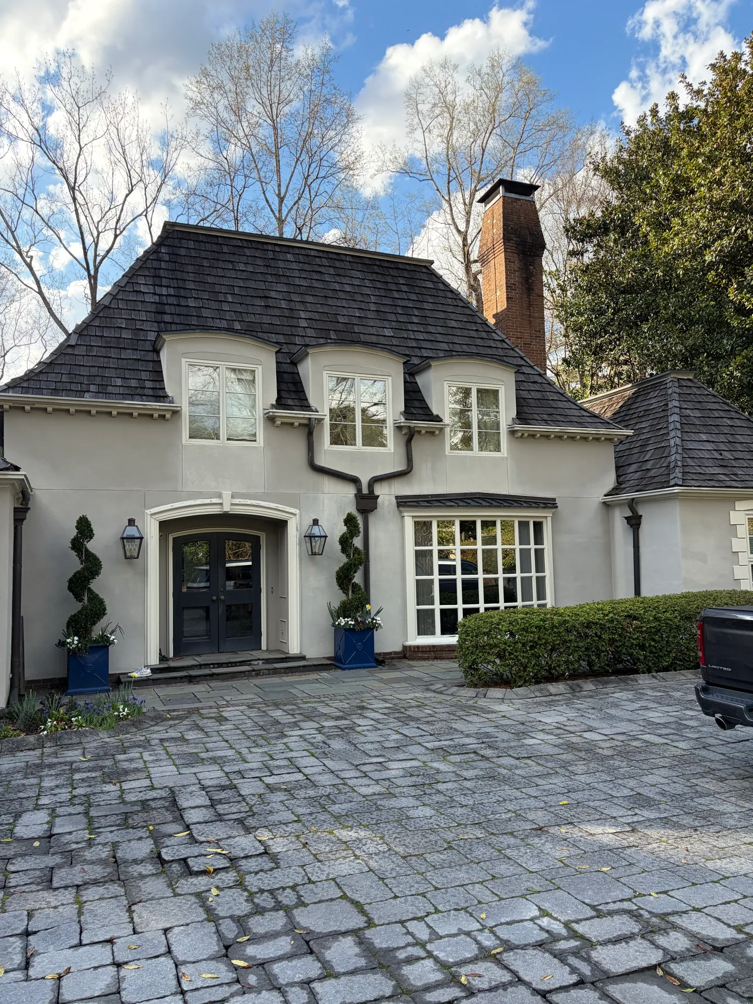 Spot-free windows on a stucco home with divided-light glass
