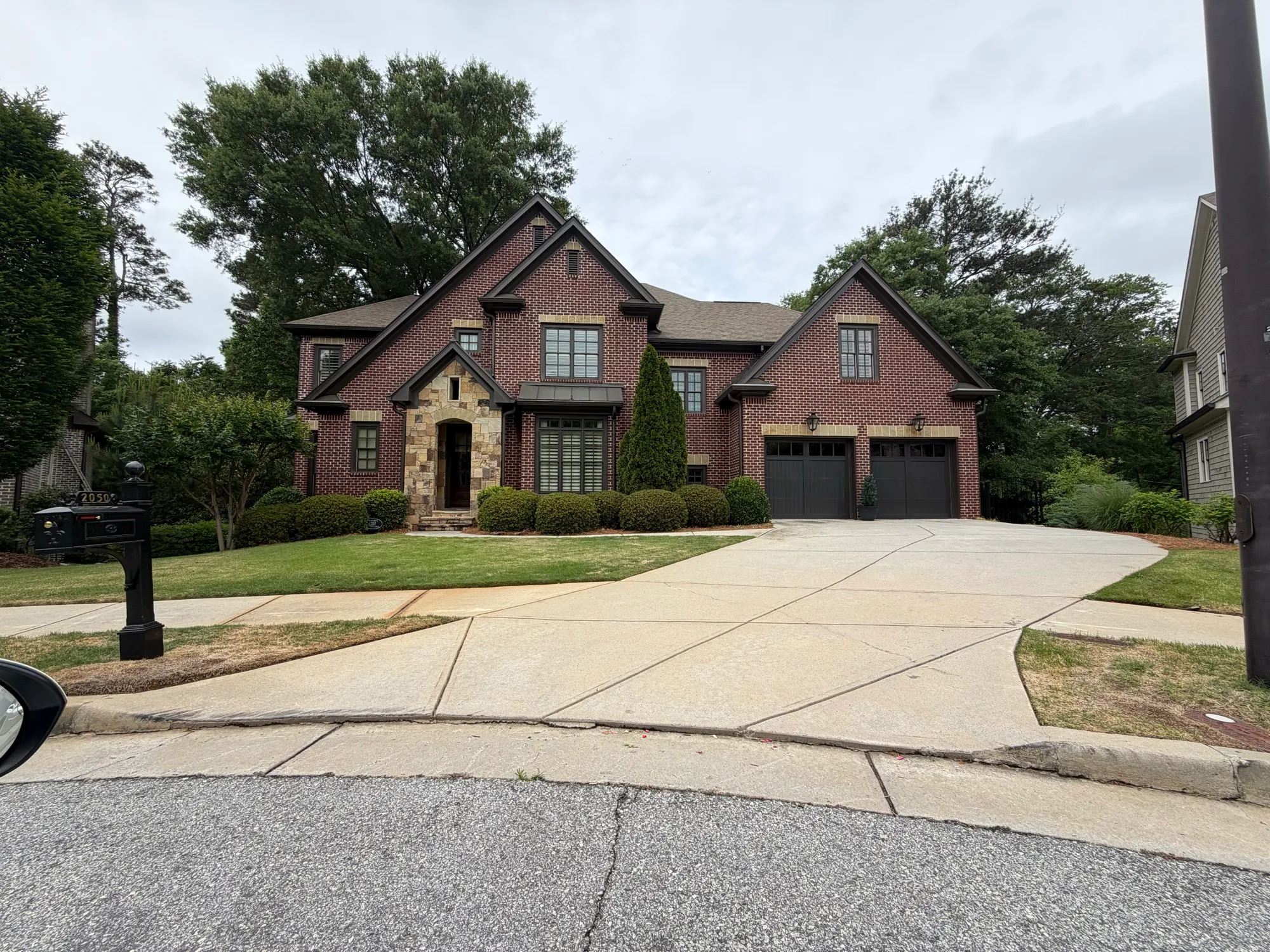 Clean exterior windows on a red brick home with stone accents