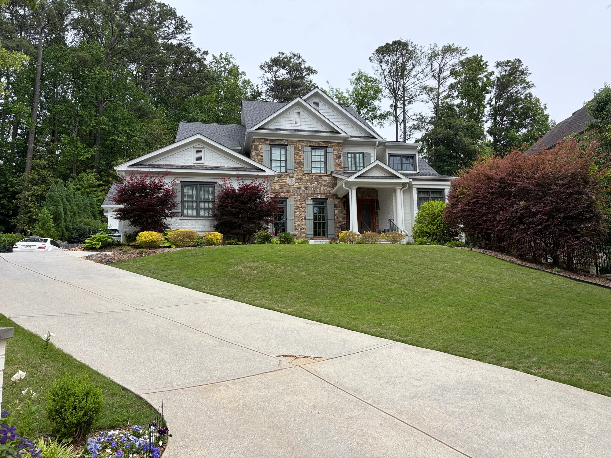 Streak-free windows on a painted brick and stone home on a hill